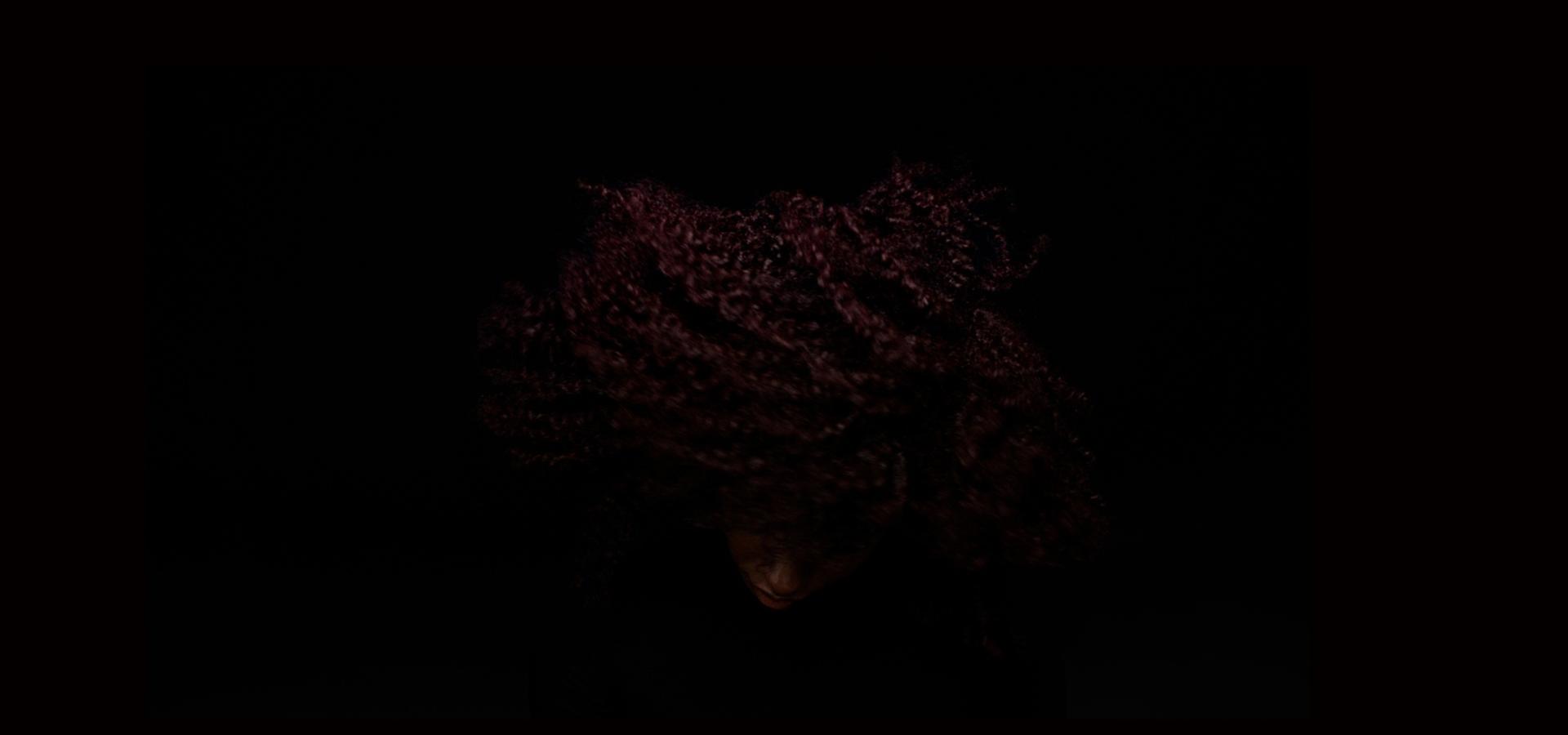 Model with curly hair after using the Dyson Chitosan Pre-style cream Curly to coily light conditioning