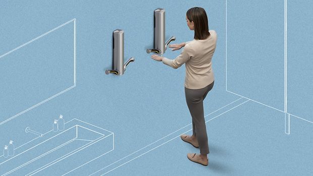 Woman using Dyson airblade to dry hands
