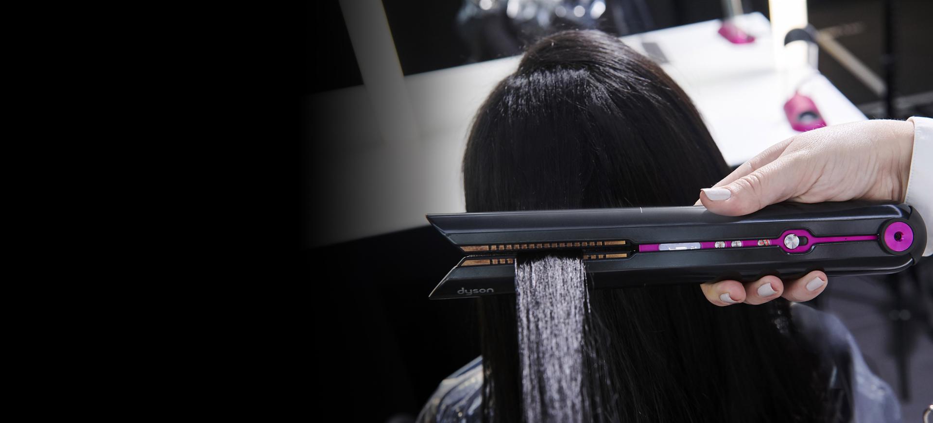 Customer and Stylist in the store with the Dyson Corrale straightener