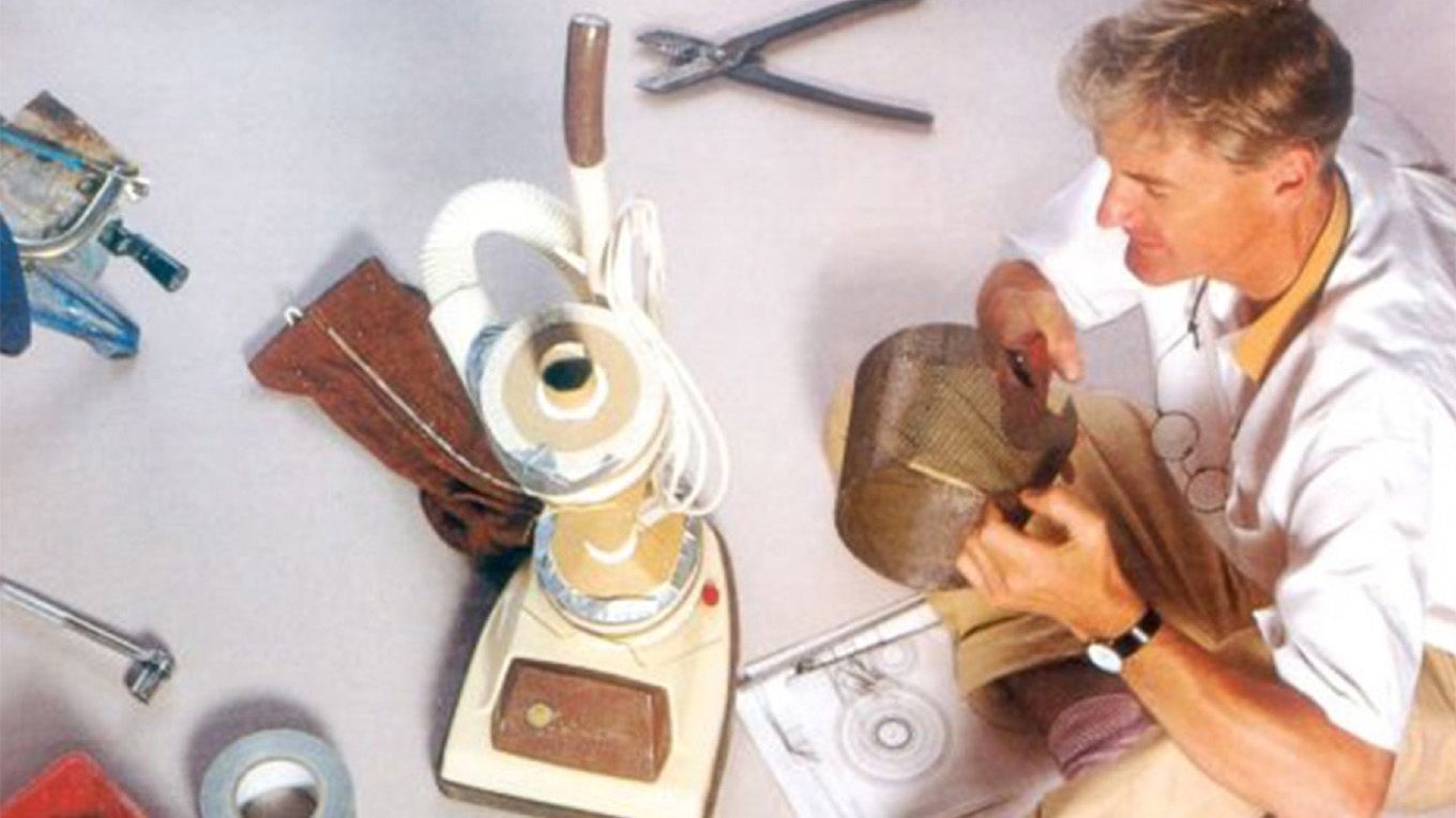 Sir James Dyson in a workshop creating the first Dyson vacuum cleaner.