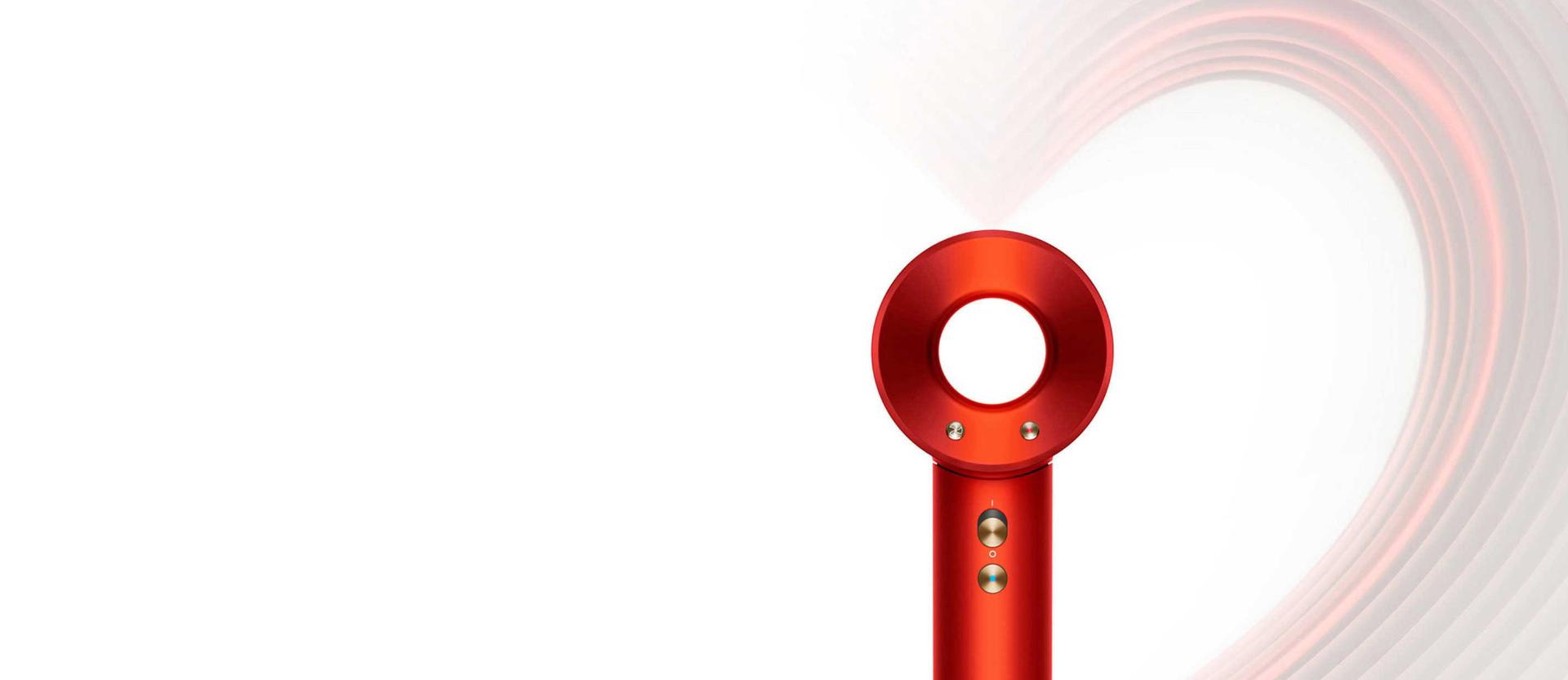 Dyson Supersonic in Topaz orange, on a heart-design background.