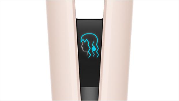 The LCD screen of the Dyson Airstrait straightener shows an icon of wet hair.