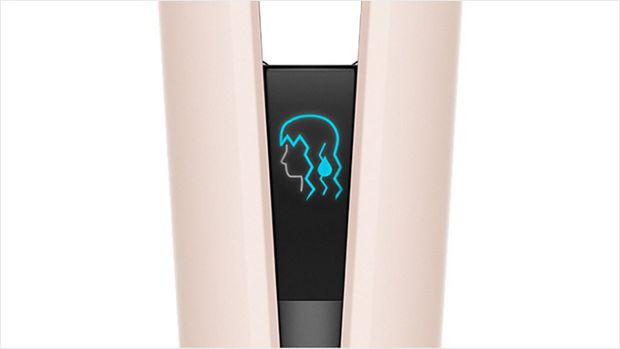 The LCD screen of the Dyson Airstrait straightener shows an icon of wet hair.