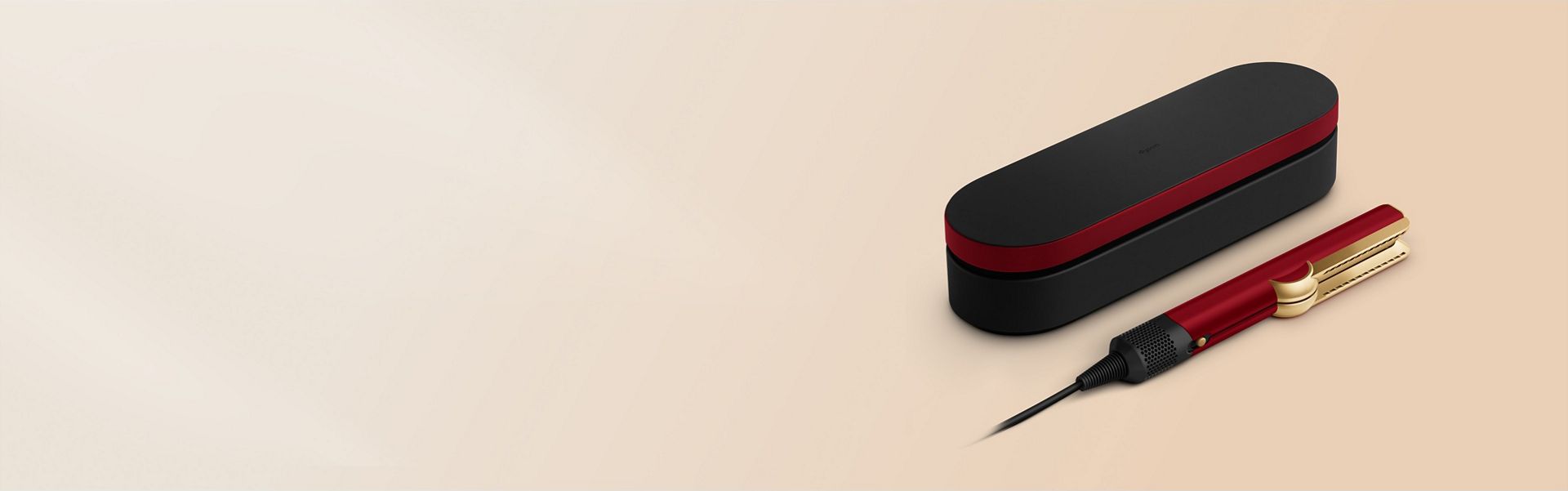 The Dyson Airstrait straightener and Presentation case in the Red velvet and gold colourway.