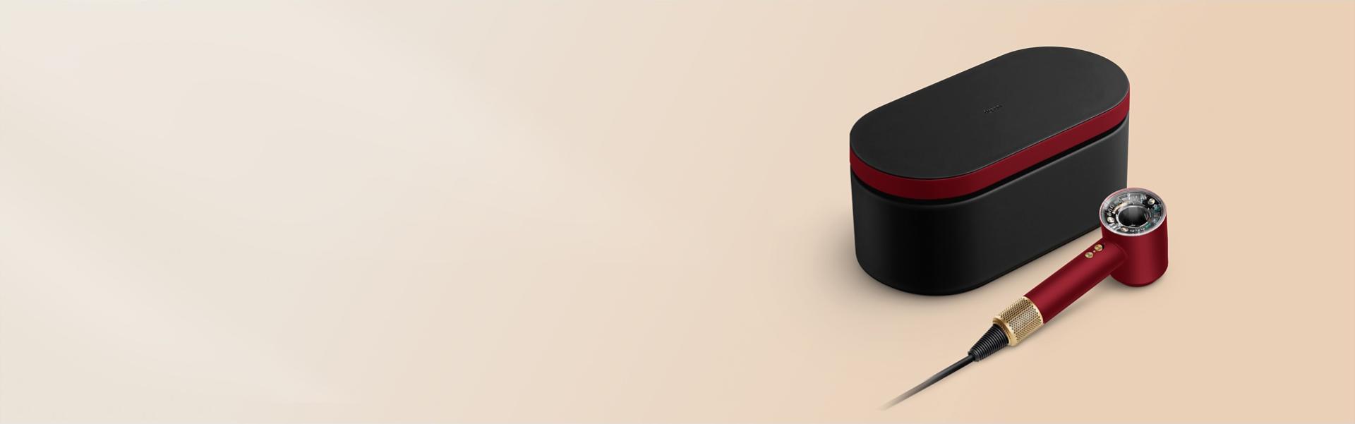 The Dyson Supersonic Nural hair dryer and Presentation case in the Red velvet and gold colourway.
