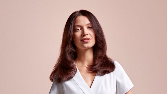A model showing off her hair styled using the Dyson Airstrait straightener.