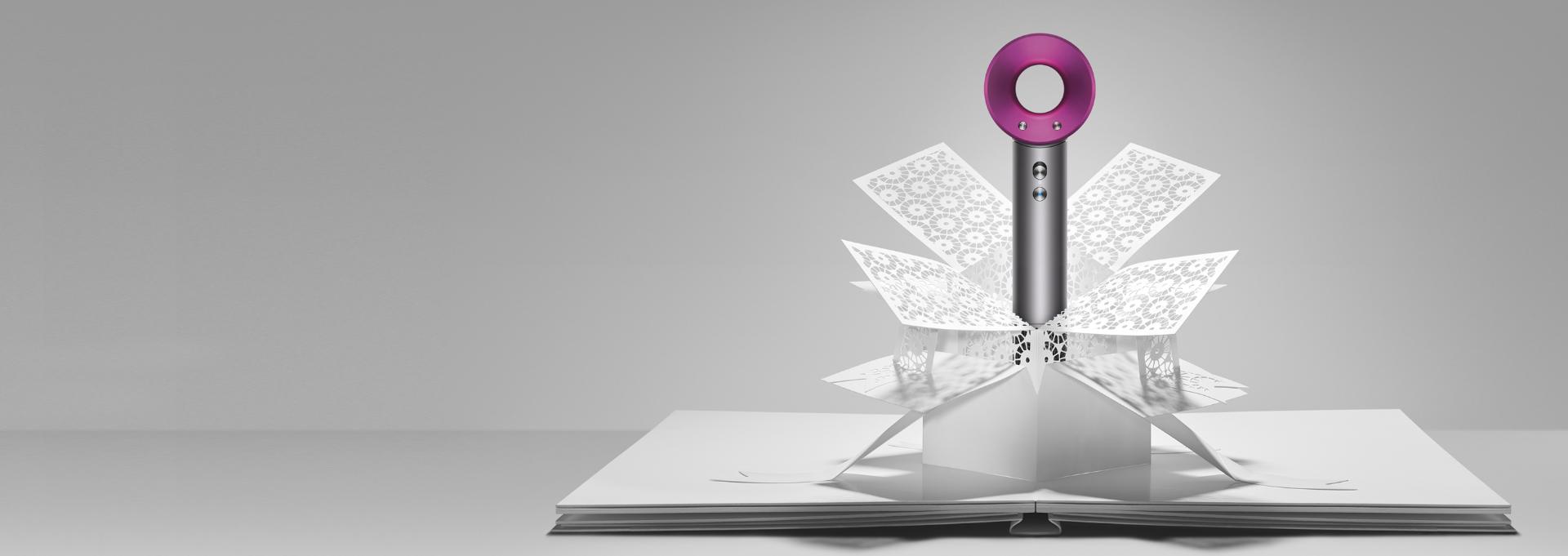 Dyson Supersonic™ hair dryer emerging from paper art