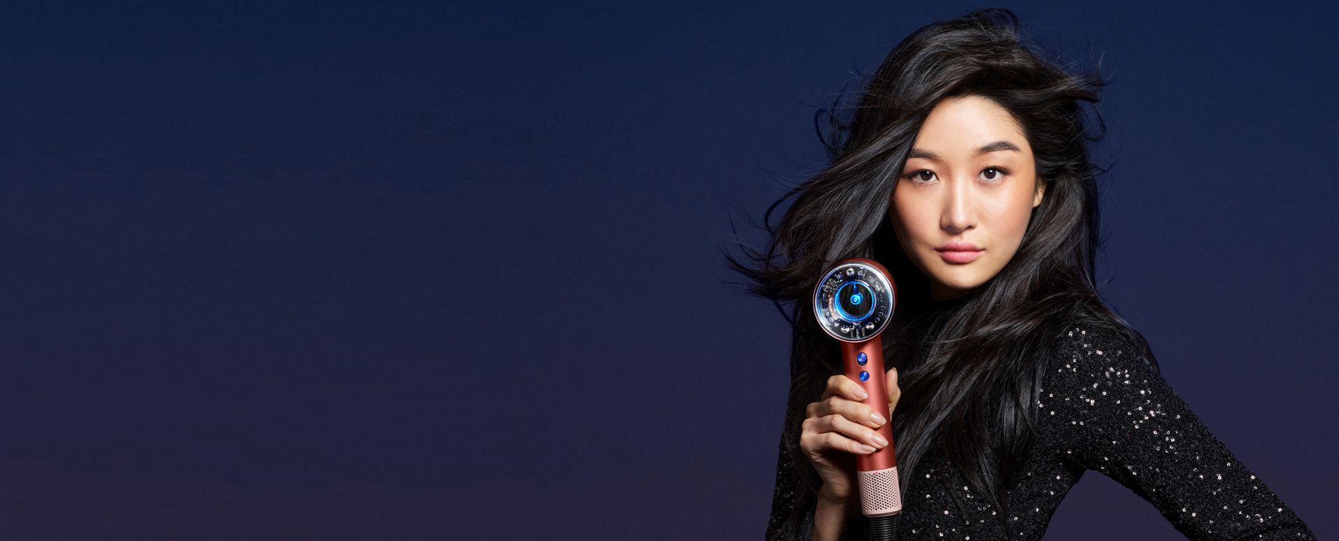 A woman uses the Dyson Supersonic Nural.