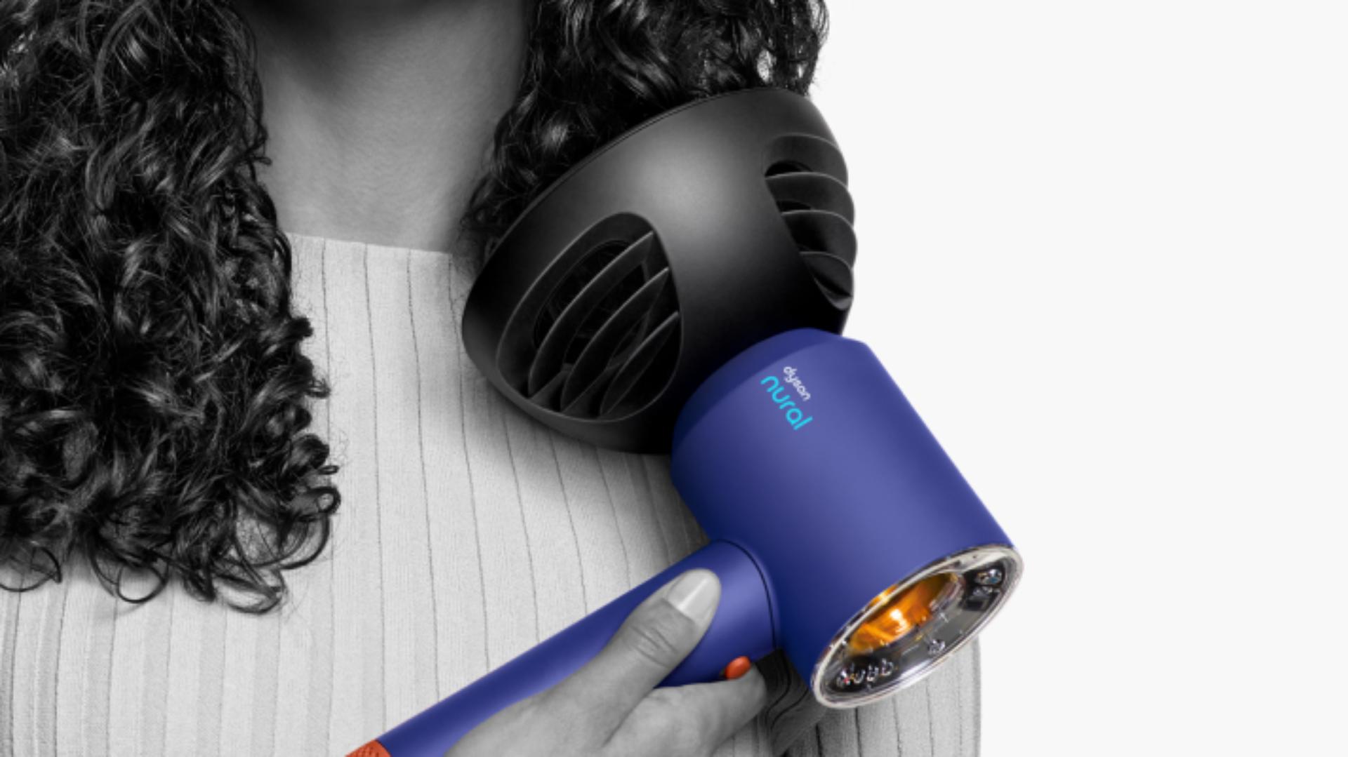 The Supersonic Nural hair dryer with Diffuser attachment in use
