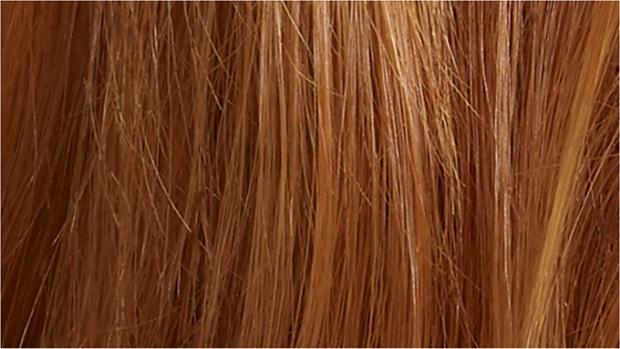 Woman straightening hair with the Dyson Corrale hair straightener