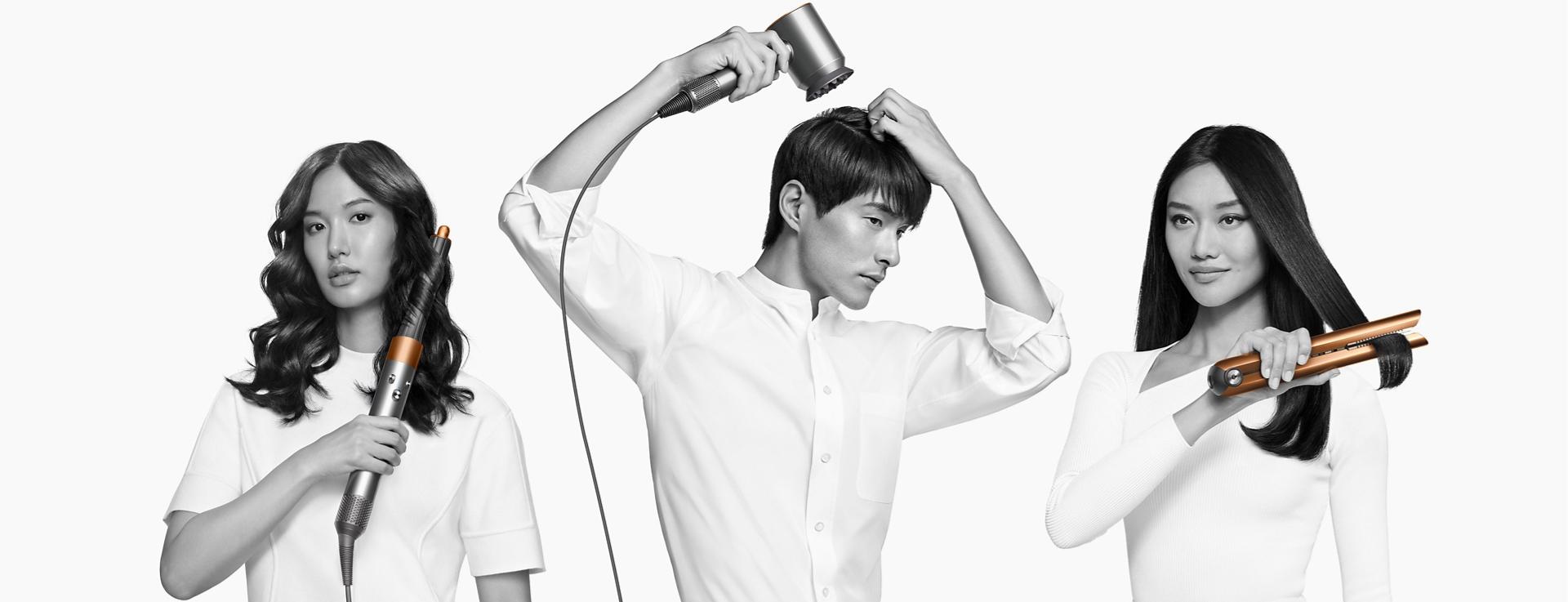 Models using the Dyson hair care range to dry or style their hair