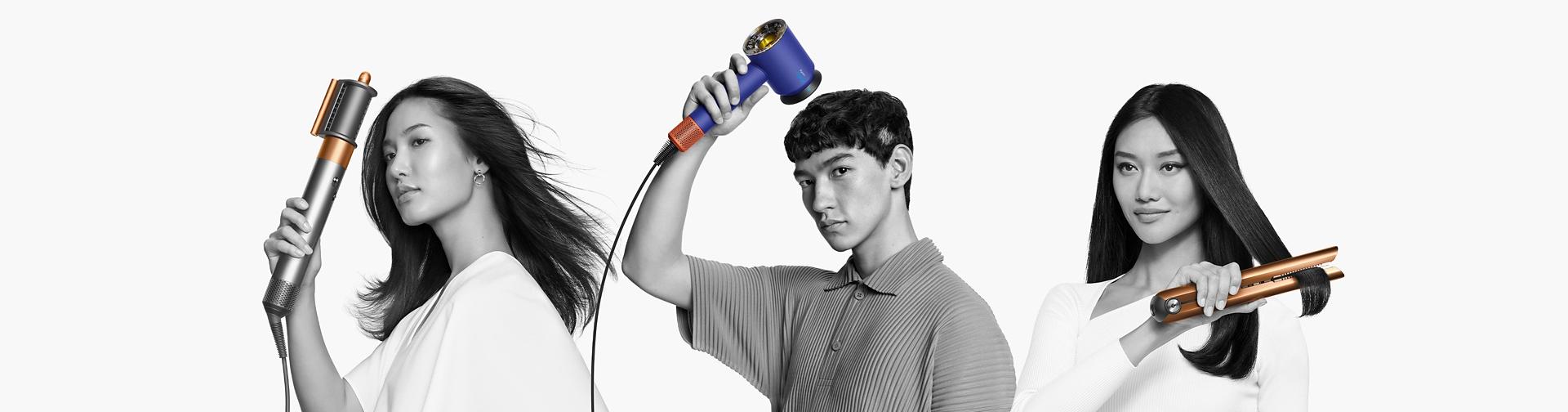 Models using the Dyson hair care range to dry or style their hair