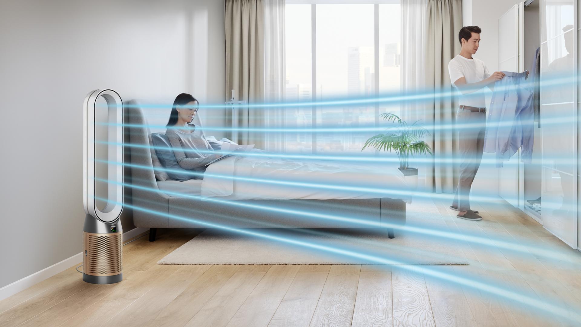 Woman in bed beside Dyson Purifier fan