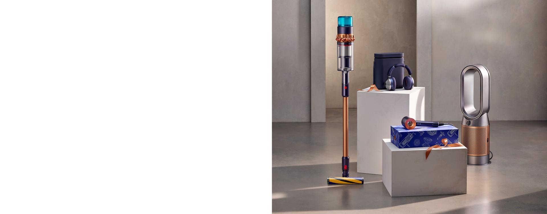 Gift box image wrapped with golden ribbon with vacuum cleaners and dyson technology