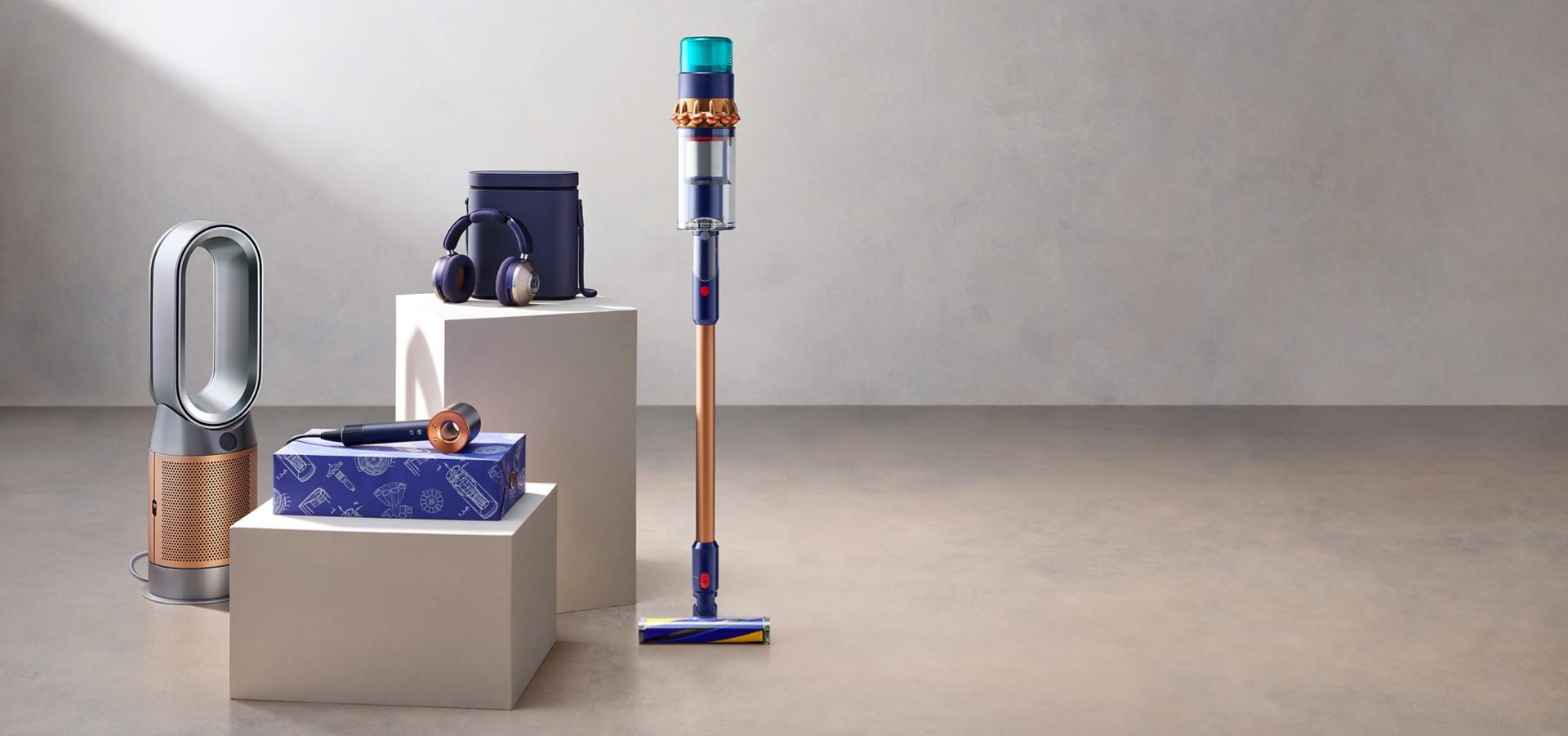 Gift box image wrapped with golden ribbon with vacuum cleaners and dyson technology