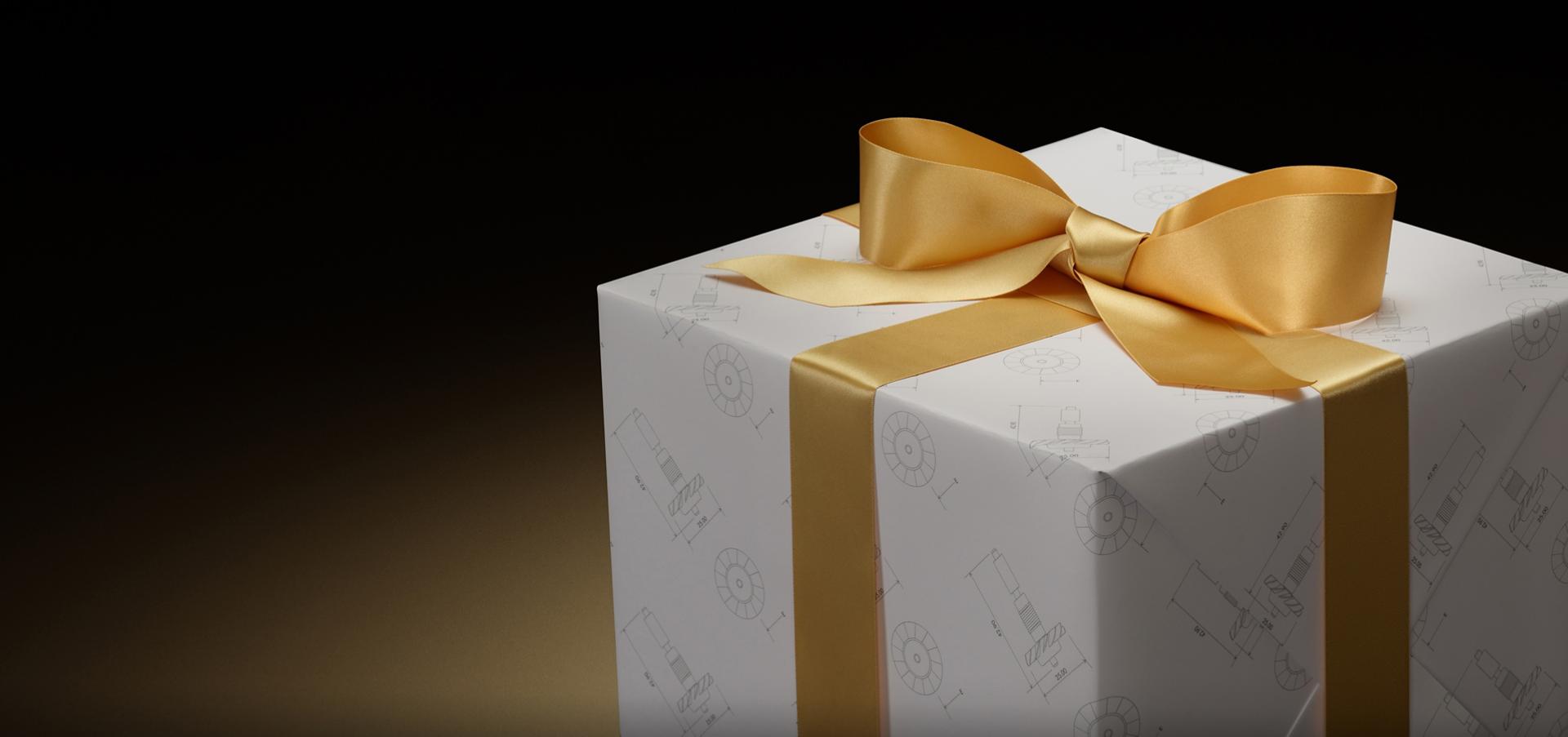 Gift box wrapped in Dyson wrapping paper and a gold ribbon.