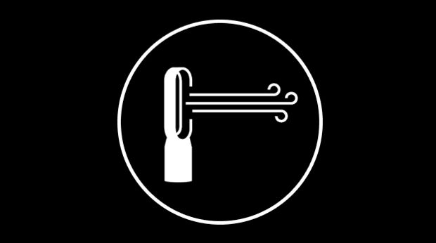 A man and woman setting the table in an open plan kitchen and dining area