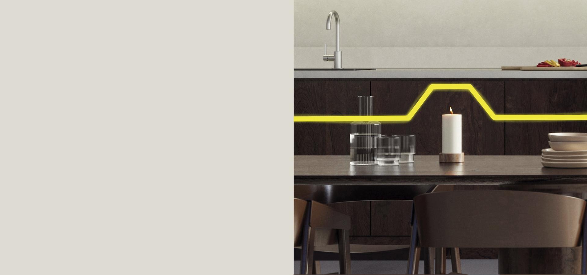 A burning candle sat on a kitchen table.