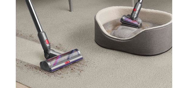 Dyson Hair screw tool cleans a pet bed, and a Motorbar cleaner head clears hair from a carpet