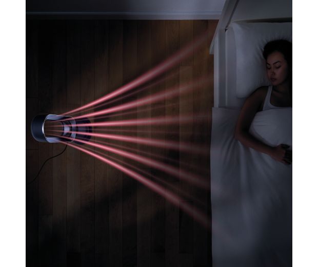 Overhead view of the Dyson Hot+Cool Jet Focus fan heater next to a bed, heating a sleeping person.