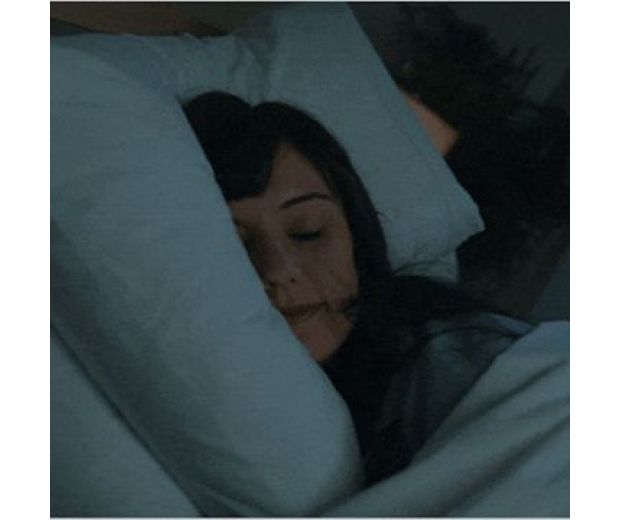 A model sleeping in bed.