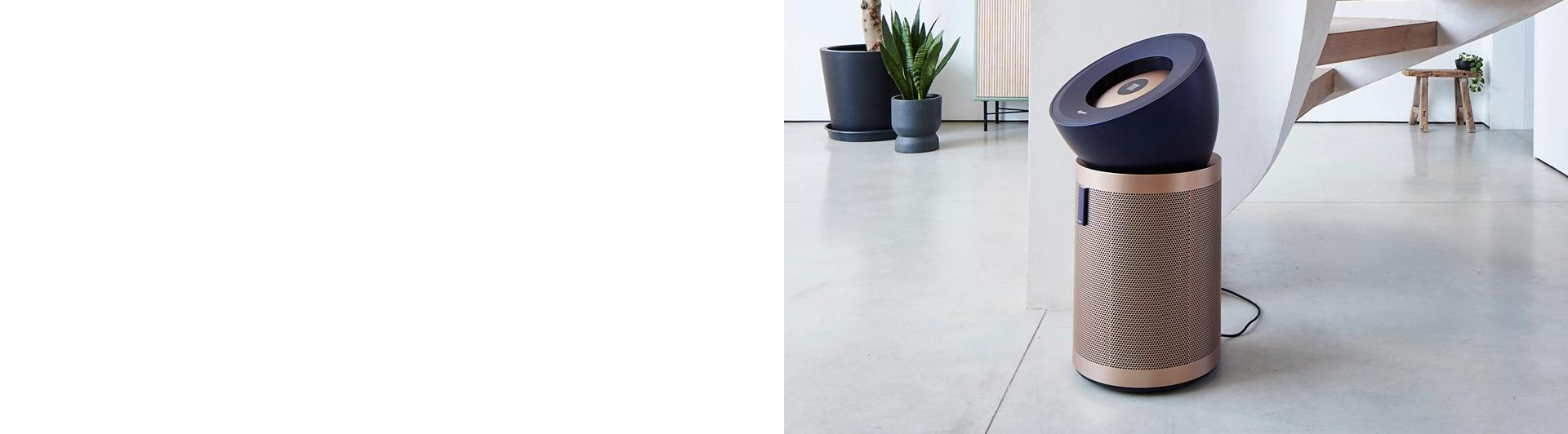 The Dyson Purifier Big+Quiet Formaldehyde in a modern home with a spiral staircase.