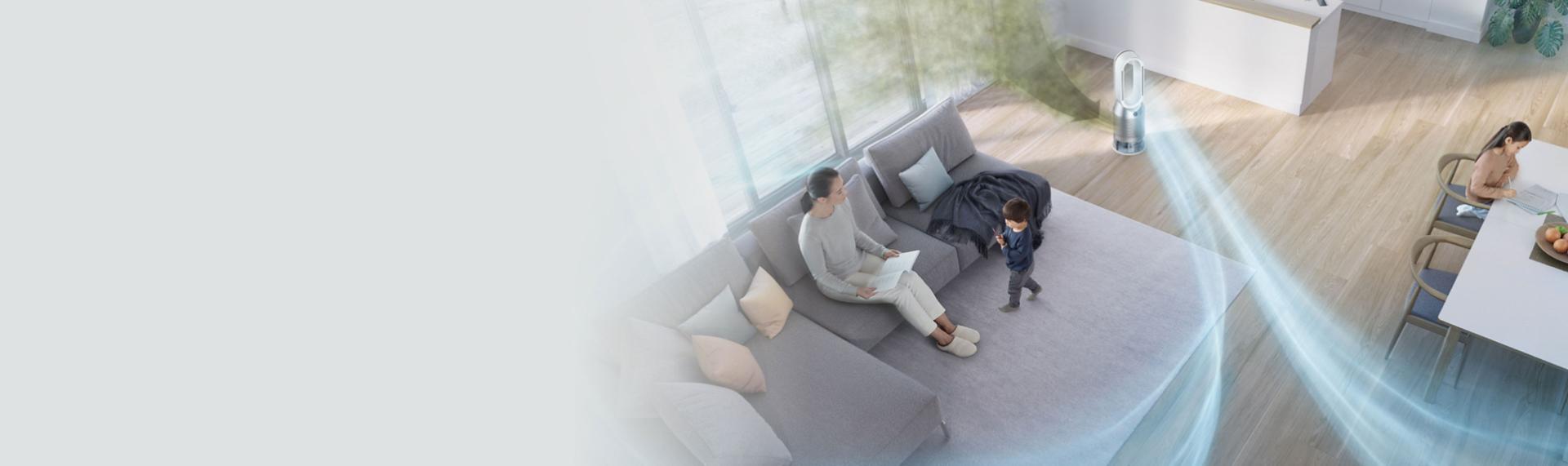The Dyson Purifier Cool Autoreact in a living room with graphics representing pollutants and clean air.
