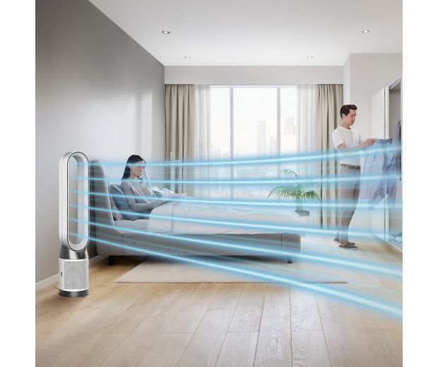 A Dyson Purifier Cool Gen1 TP10 purifying fan operates next to a person in a bed.
