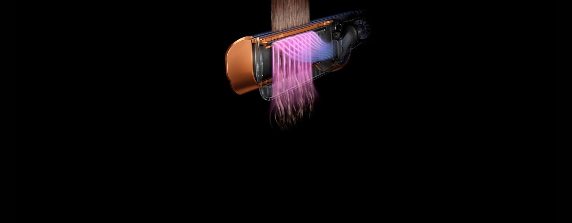 Close-up of the Dyson Airstrait straightener showing warm airflow straightening hair.