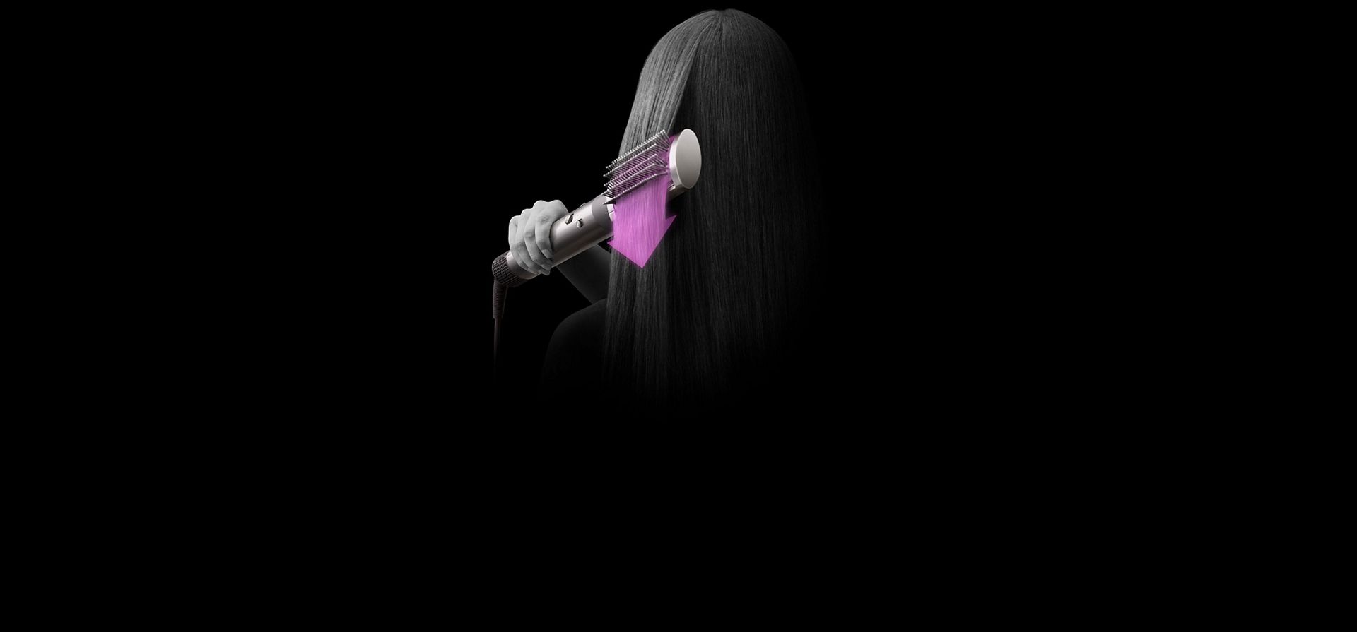 A close up of the back of a woman's head as she shapes her hair with the Dyson Airwrap multi-styler and dryer