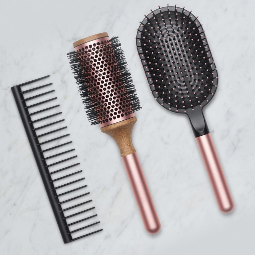 The Dyson Detangling comb, Vented Barrel brush, and Paddle brush.