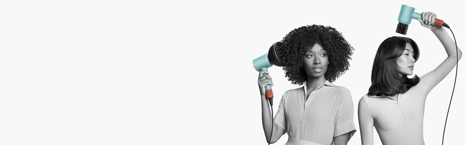 A woman with coily, voluminous hair and a man with short blunt hair