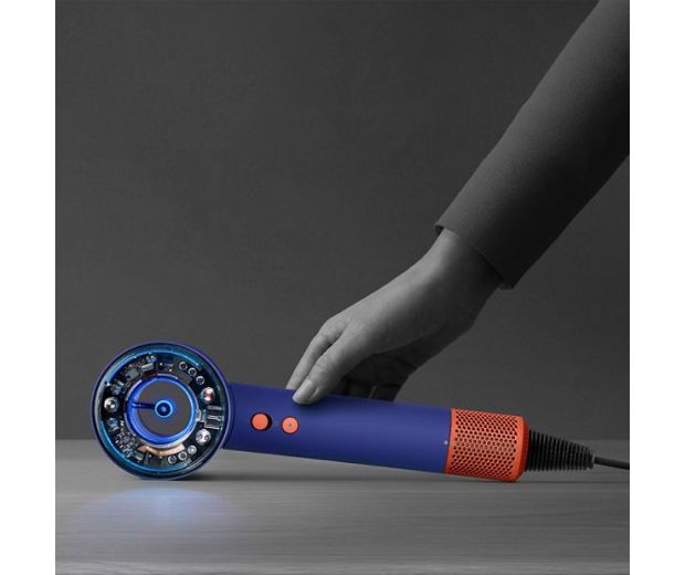 The Dyson Supersonic Nural hair dryer is rested on a table, activating the Pause detect mode.