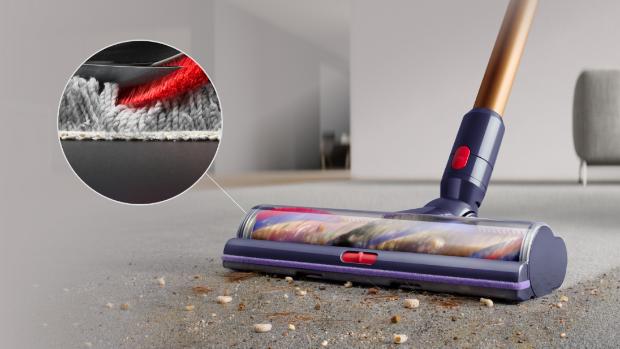 Low-angle close-up of the Digital Motorbar XL cleaner head removing debris from carpet.