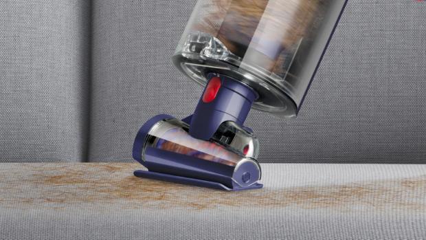 Close-up of the Hair screw tool removing pet hair from a sofa.