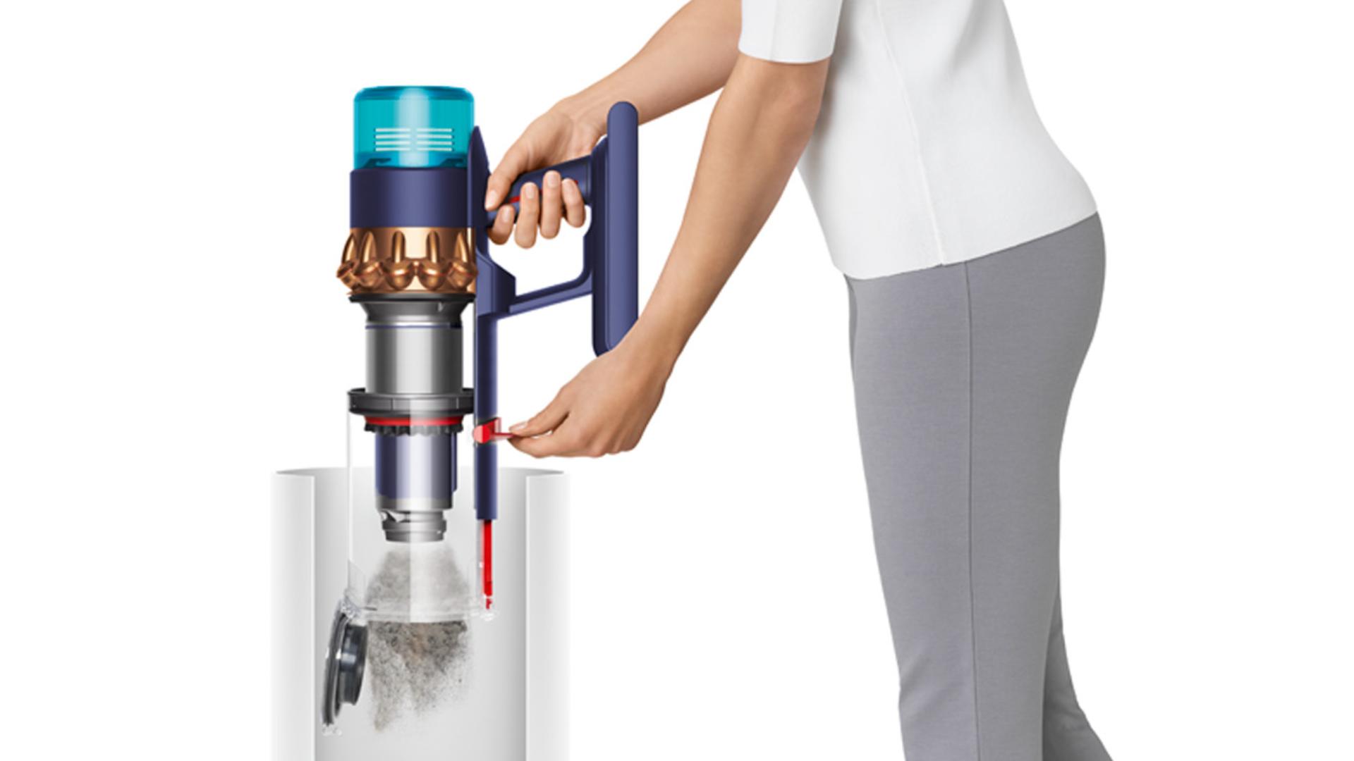 A woman empties the Dyson Gen5detect vacuum's bin in one action.