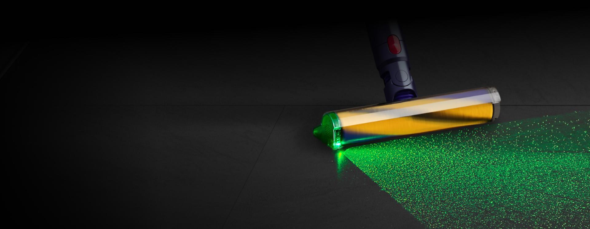 The Fluffy Optic cleaner head illuminating dust on the floor.