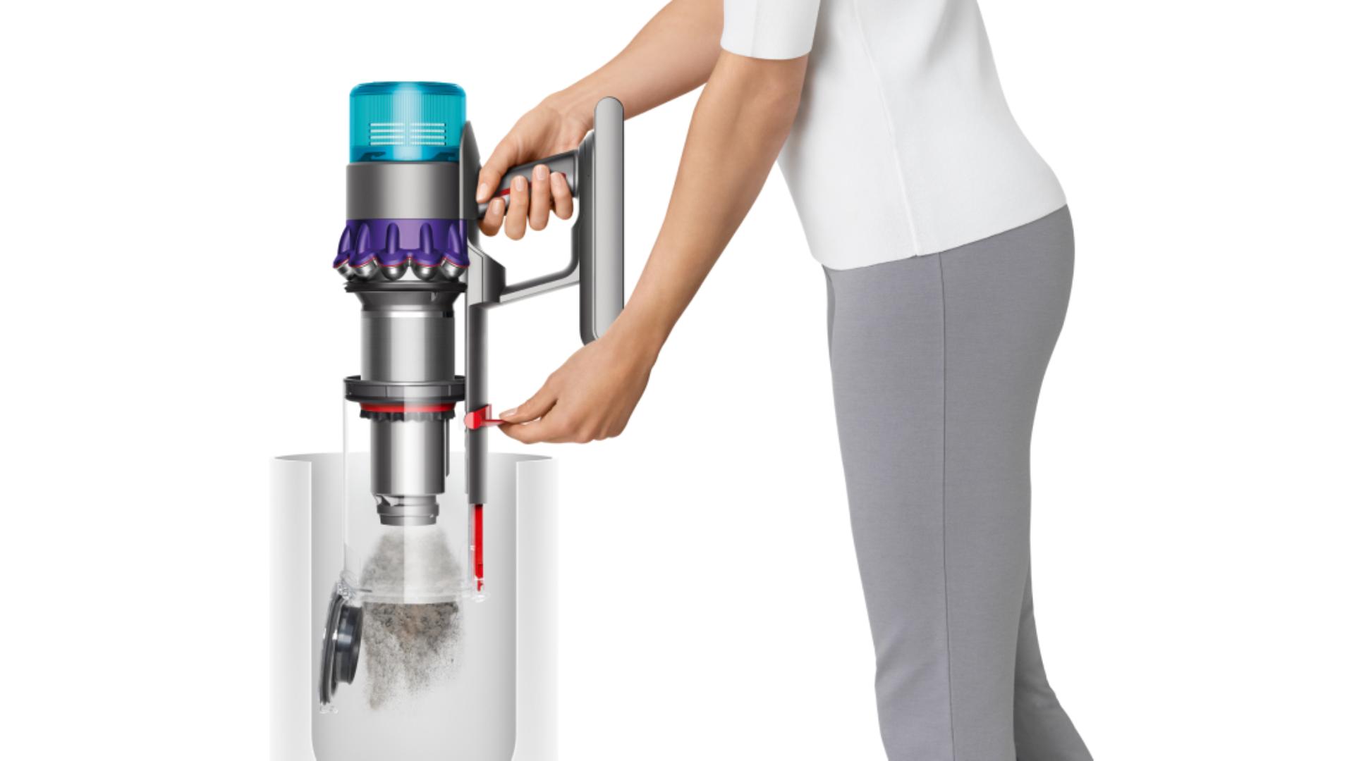 A woman empties the Dyson Gen5detect vacuum's bin in one action.