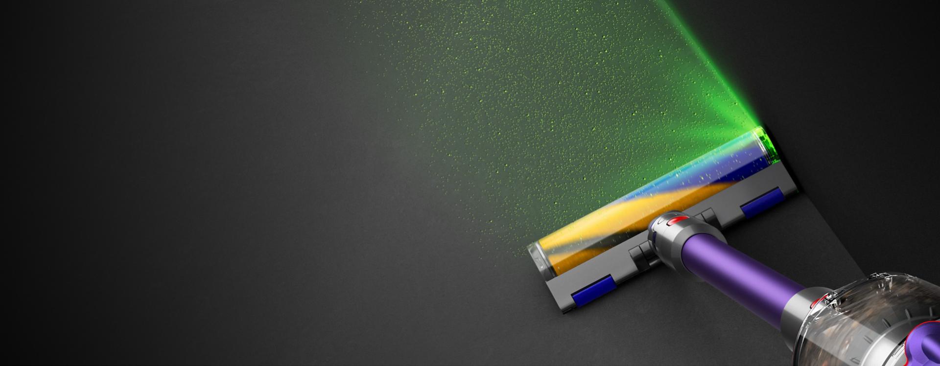 The Fluffy Optic cleaner head illuminating dust on the floor.