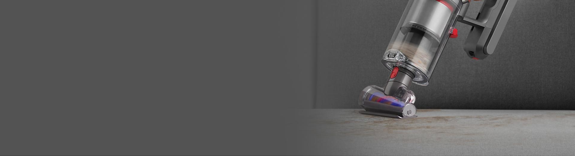 Dyson Gen5detect vacuum cleaning upholstery in handheld mode with the Hair screw tool attached.