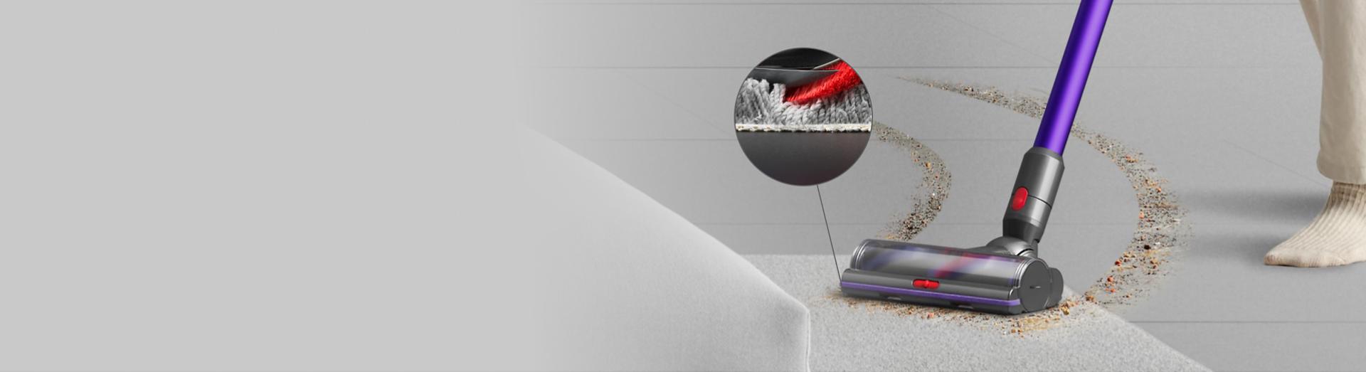 Cleaning a clear path through debris on hard floor and carpet, with a close-up of the cleaner head bristles removing dirt.
