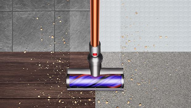 Dyson V10 picking up debris from floor. 