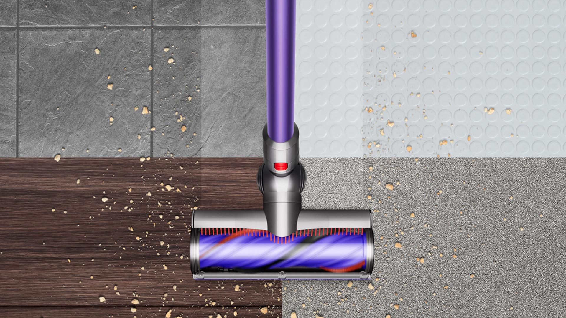 Dyson V10 picking up debris from floor.
