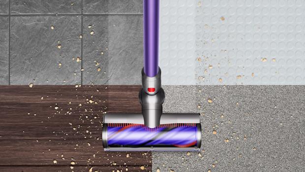 Dyson V10 picking up debris from floor.