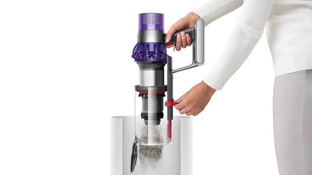Dyson V10 being emptied into a bin.
