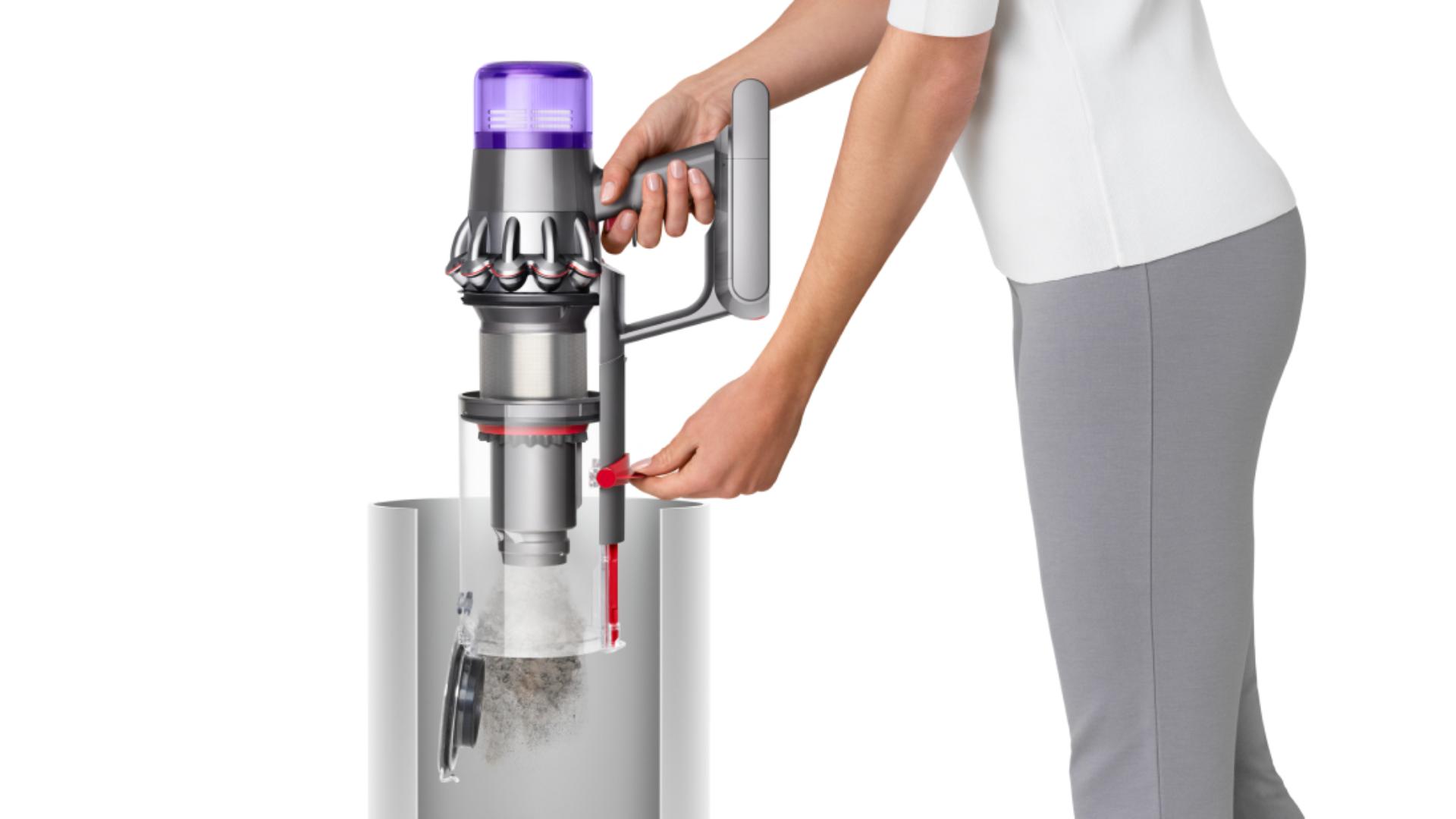 A model emptying the Dyson V11 Total Clean.