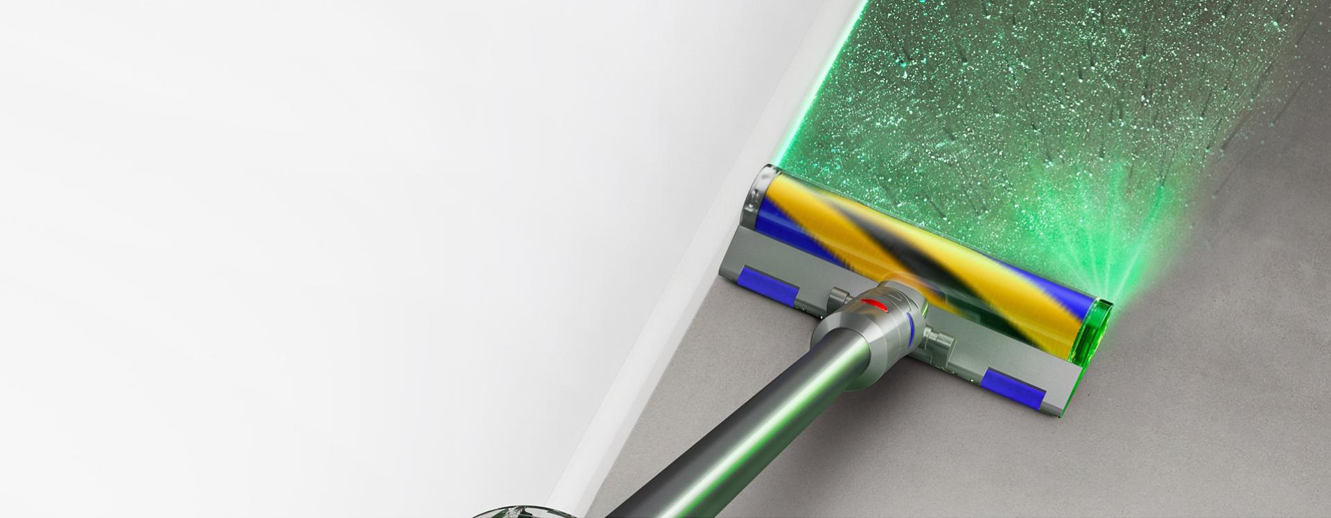 The Dyson V12 Detect Slim Absolute with Fluffy Optic cleaner head illuminating dirt on hard floor.
