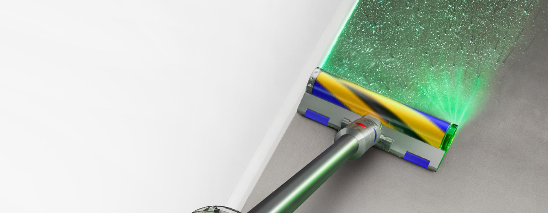 The Dyson V12 Detect Slim Absolute with Fluffy Optic cleaner head illuminating dirt on hard floor.