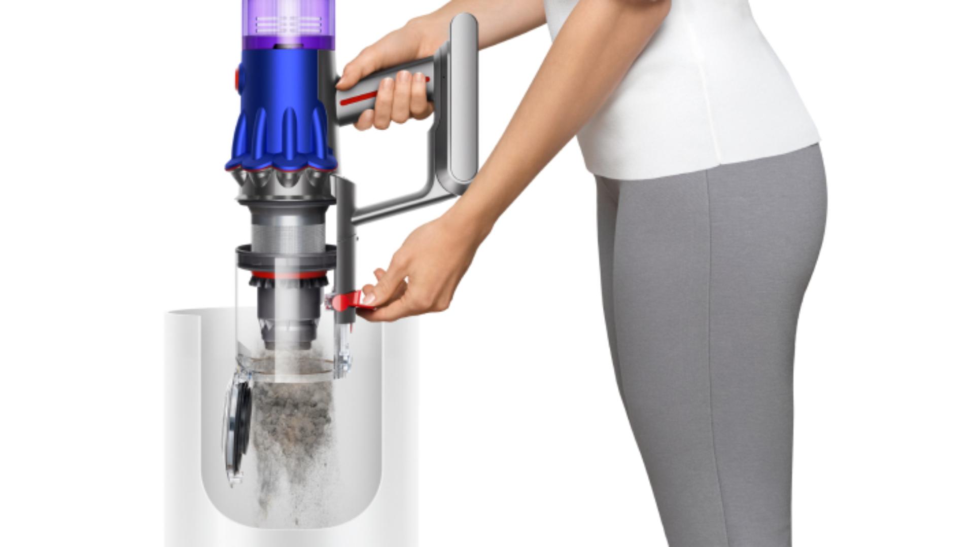 Someone emptying the bin of the Dyson V12 Detect Slim vacuum.