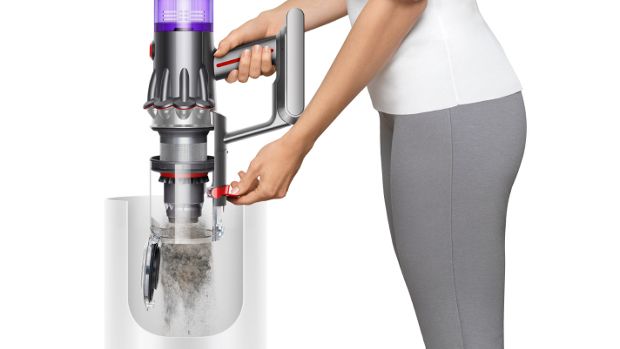 Someone emptying the bin of the Dyson V12 Detect Slim vacuum.